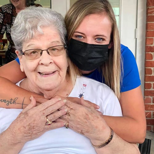 masked caregiver and resident at Canoe Brook Assisted Living in Ardmore, Oklahoma