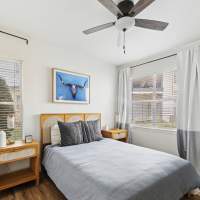 Bright bedroom with wood-style flooring at Sutton in Austin, Texas