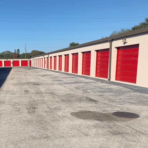 Outdoor storage units with red doors at StorQuest Self Storage in Clearwater, Florida