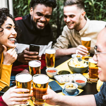 A group of friends having a drink together near Cypress Creek at River Bend in Georgetown, Texas