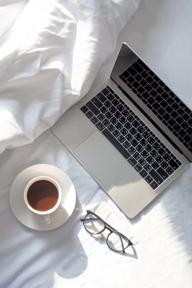 Laptop in a bed at Sulzbacher Village in Jacksonville, Florida