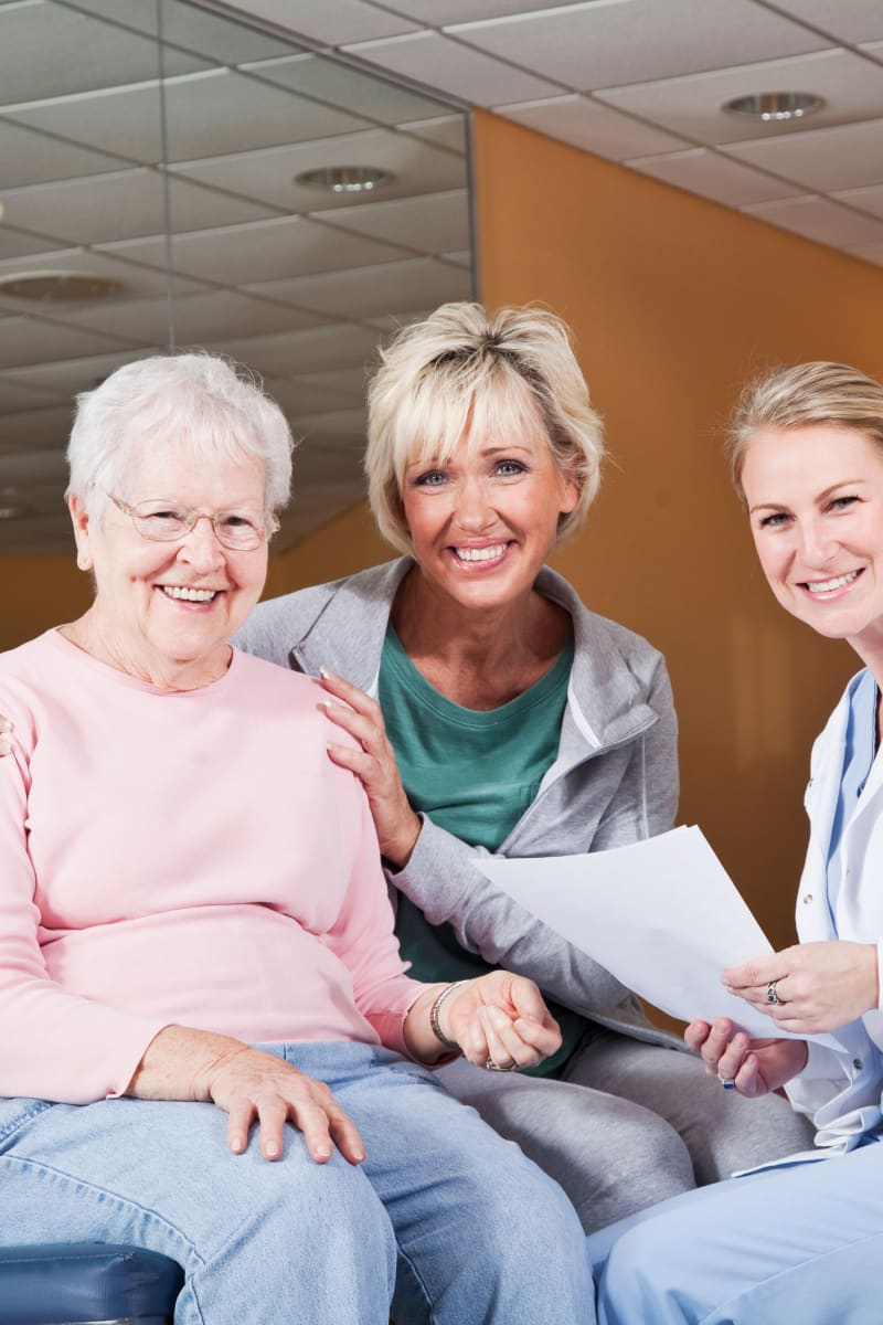 Resident with a younger family member talking to a doctor at Edgerton Care Center in Edgerton, Wisconsin