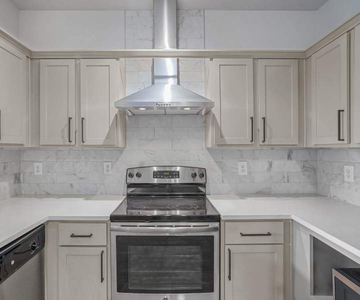 Kitchen with gray cabinets at Trinity Bluff & Trinity District in Fort Worth, Texas