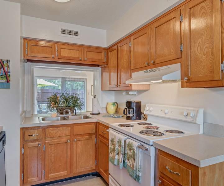 Kitchen with wooden cabinets at Carlton Arms Of St. Petersburg in St Petersburg, Florida