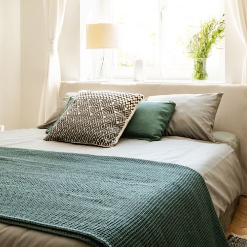 A cozy bed in a home at Vista Ridge in Vista, California