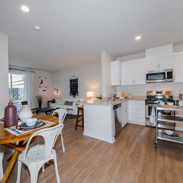 View of open-concept floor plan with hardwood floors in model home at IMT Sherman Circle in Van Nuys, CA