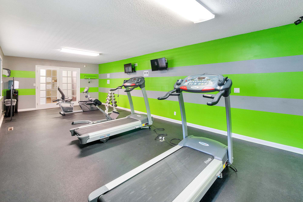 Fitness center with green walls at The Hills at Oakwood Apartment Homes in Chattanooga, Tennessee