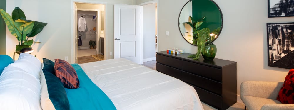 A bedroom with on-suite bathroom and plenty of closet space at SoLa Apartments in Los Angeles, California