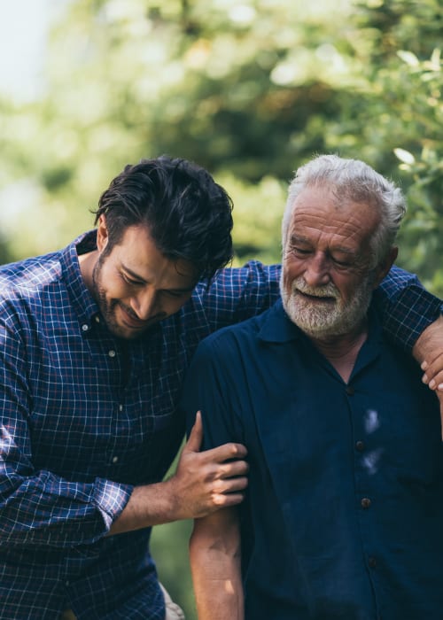 Resident walking outdoors with a family member at Burton Health Care Center in Burton, Ohio