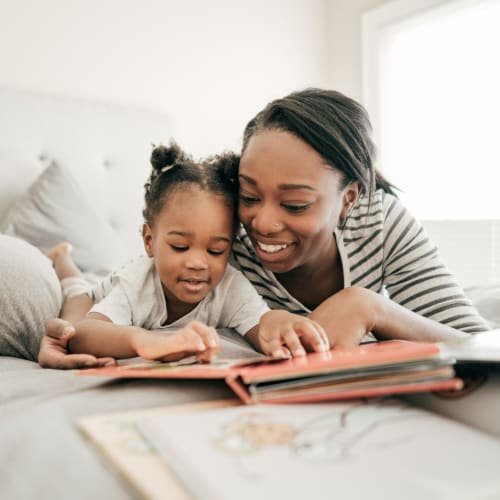 A mother reading a story with  her kid at Longshaw Road in Annapolis, Maryland