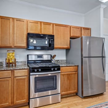 Upgraded kitchen appliances and wood flooring in a kitchen at Cypress Creek Wayside Drive in Houston, Texas