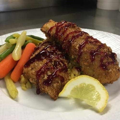 Fried chicken with vegetables served at First & Main of Auburn Hills in Auburn Hills, Michigan