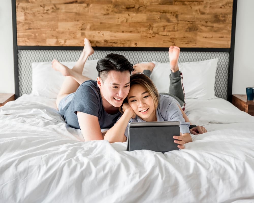 Two residents relaxing on a bed in a home at Gela Point in Virginia Beach, Virginia