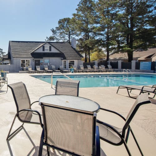 Tables and chairs by the pool at Vesta Creeks Run in North Charleston, South Carolina
