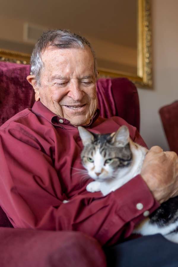 Resident holding his cat at Merrill Gardens at Rolling Hills Estates in Rolling Hills Estates, California