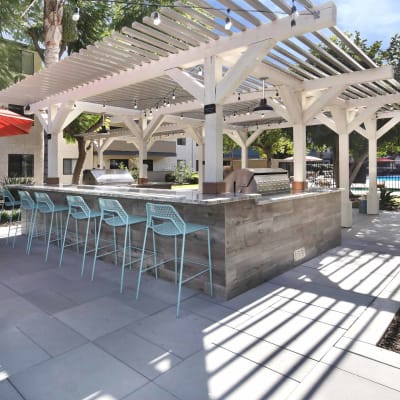 Barbecue area with gas grills and pergola at Haven Warner Center in Canoga Park, California