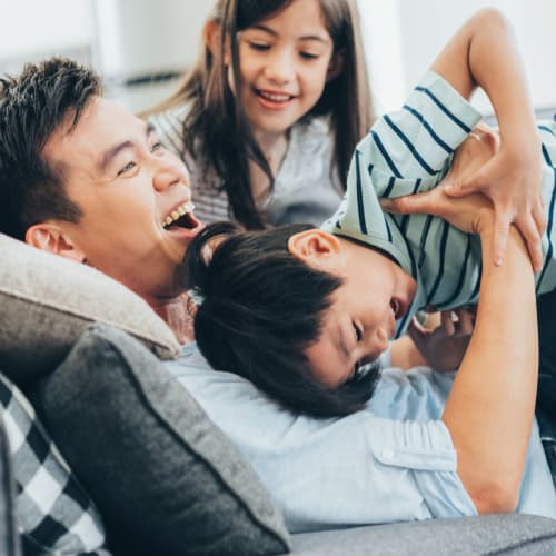 A father playing with his kids at Bard Estates in Port Hueneme, California