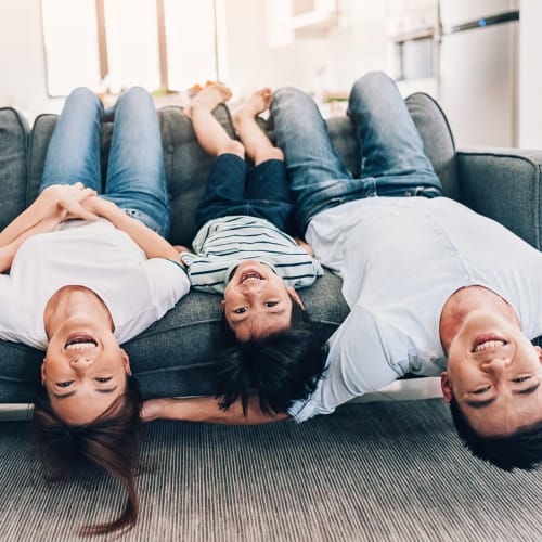 A family hanging upside down on a couch at Albany Hill Village in Albany, Georgia