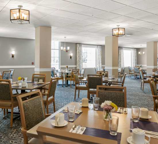 Dining room with tables at Amira Choice Champlin in Champlin, Minnesota.