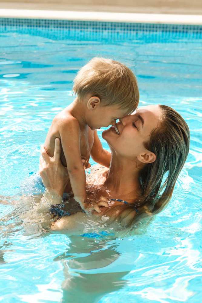 Resident and her kid in the swimming pool at Pine Lake Village in Houston, Texas