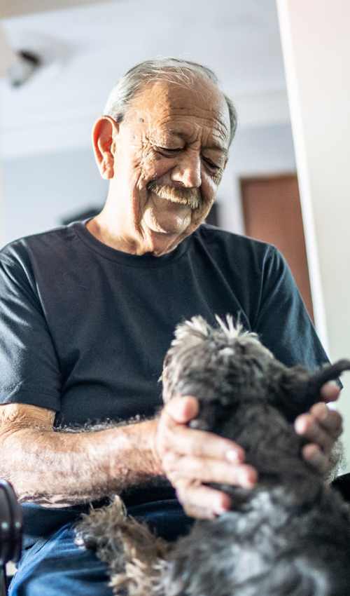 Resident holding his pet at Vintage at Redfield in Reno, Nevada