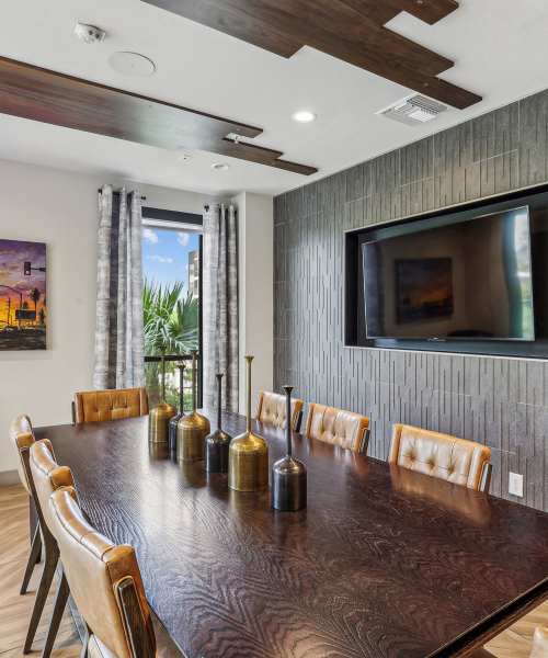 Dining area with a table, chairs and a TV at Portrait At Hance Park in Phoenix, Arizona