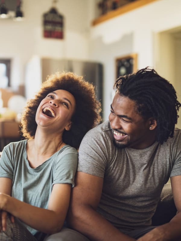 Happy couple with share a laugh at Axiom Tustin in Tustin, California