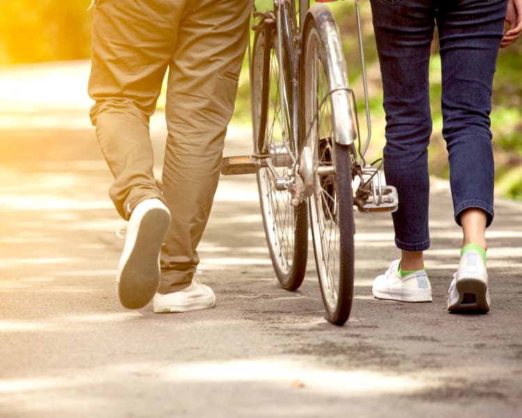 couple walking with bike near The Vibe at Clear Lake
