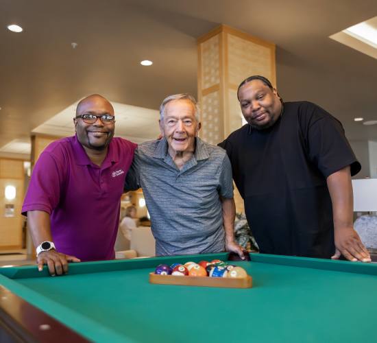 Residents playing billiards together at Truewood by Merrill, New Bern in New Bern, North Carolina