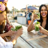 Happy friends having drinks near Agave Courtyard in El Paso, Texas 