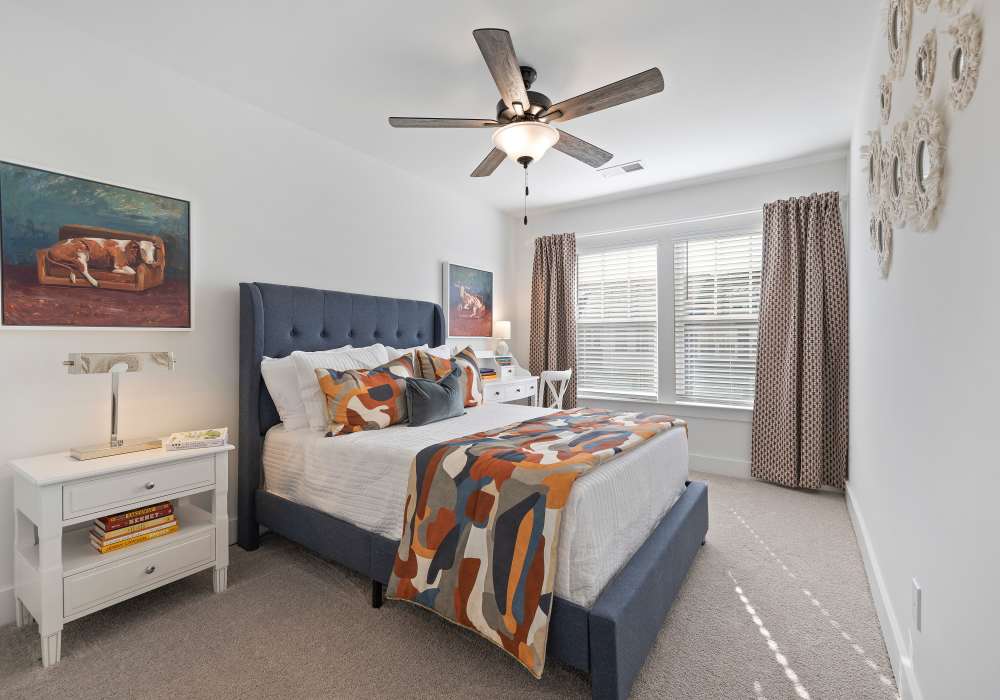 Model bedroom with a ceiling fan at Artisan Living Mills River in Mills River, North Carolina