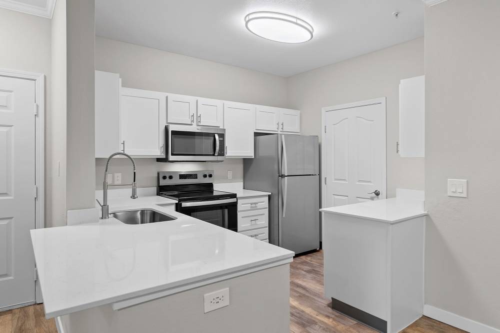 Apartment kitchen with stainless-steel appliances at Cortland Village Apartment Homes in Hillsboro, Oregon