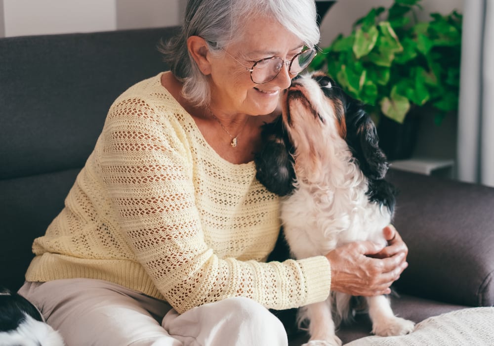 Resident embracing her pup in their home at Turners Rock in Springfield, Missouri