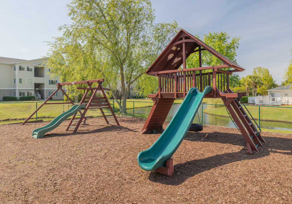 Playground with slides and jungle gyms on a soft mulch surface at River Landing in Myrtle Beach, South Carolina