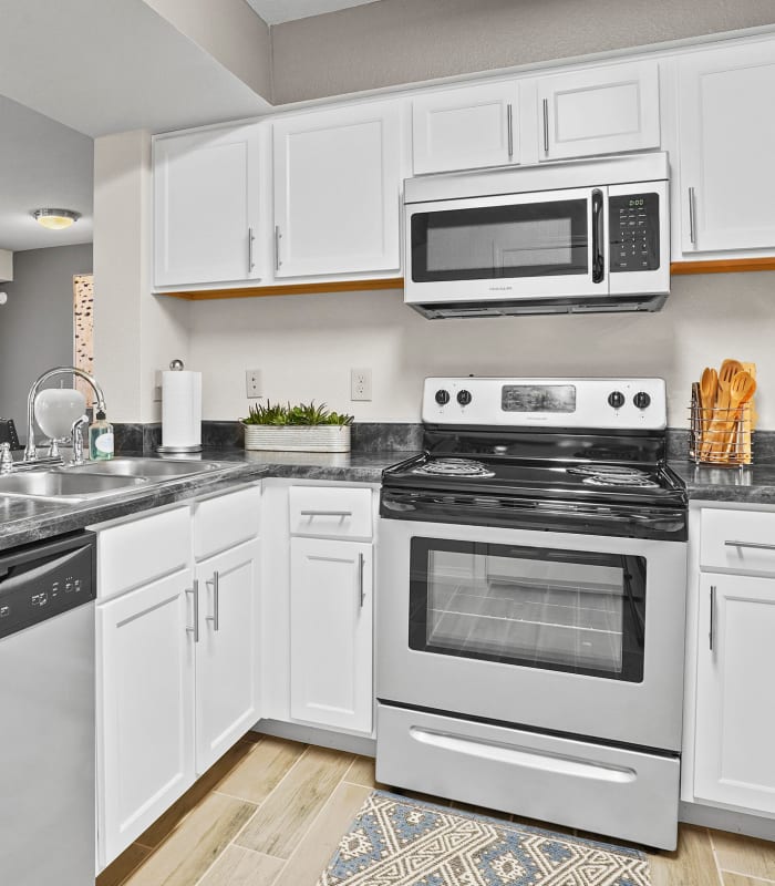 Kitchen with granite countertops at Cottages at Tallgrass Point Apartments in Owasso, Oklahoma