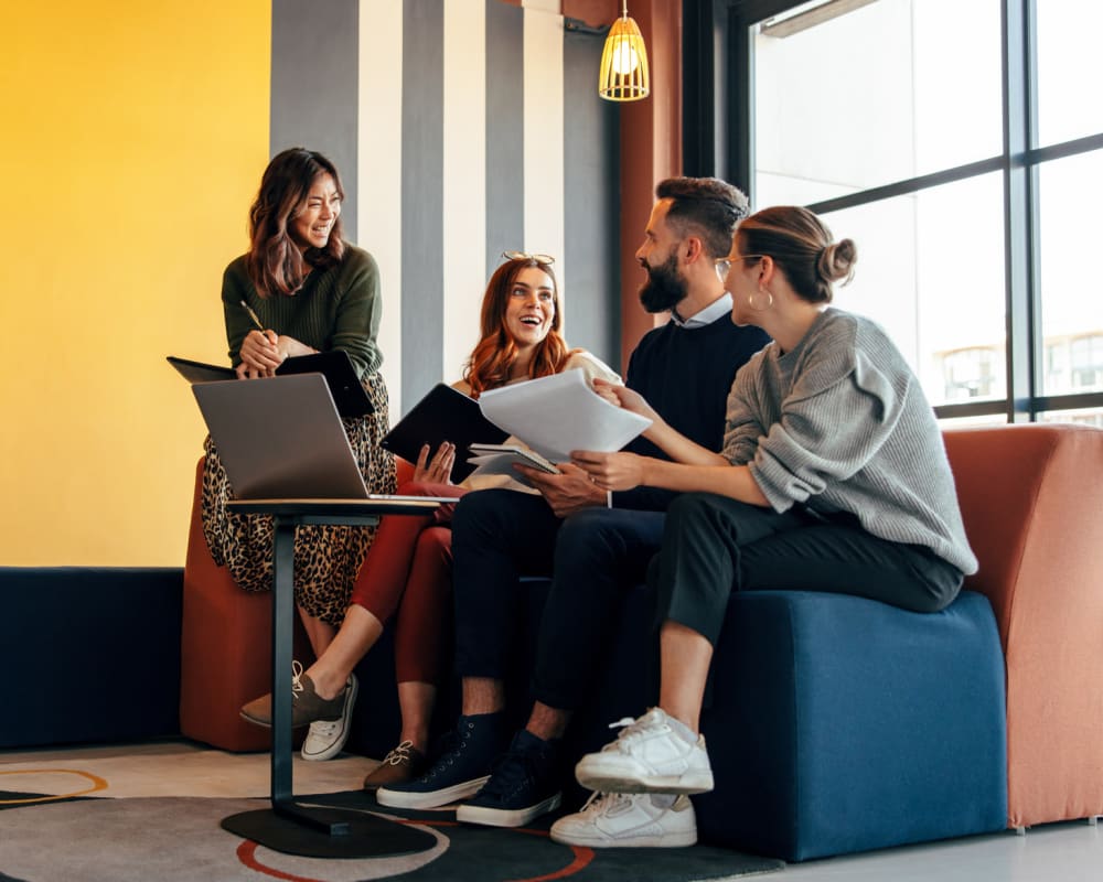 Employees sitting and collaborating at Allegiant-Carter Management in Tampa, Florida