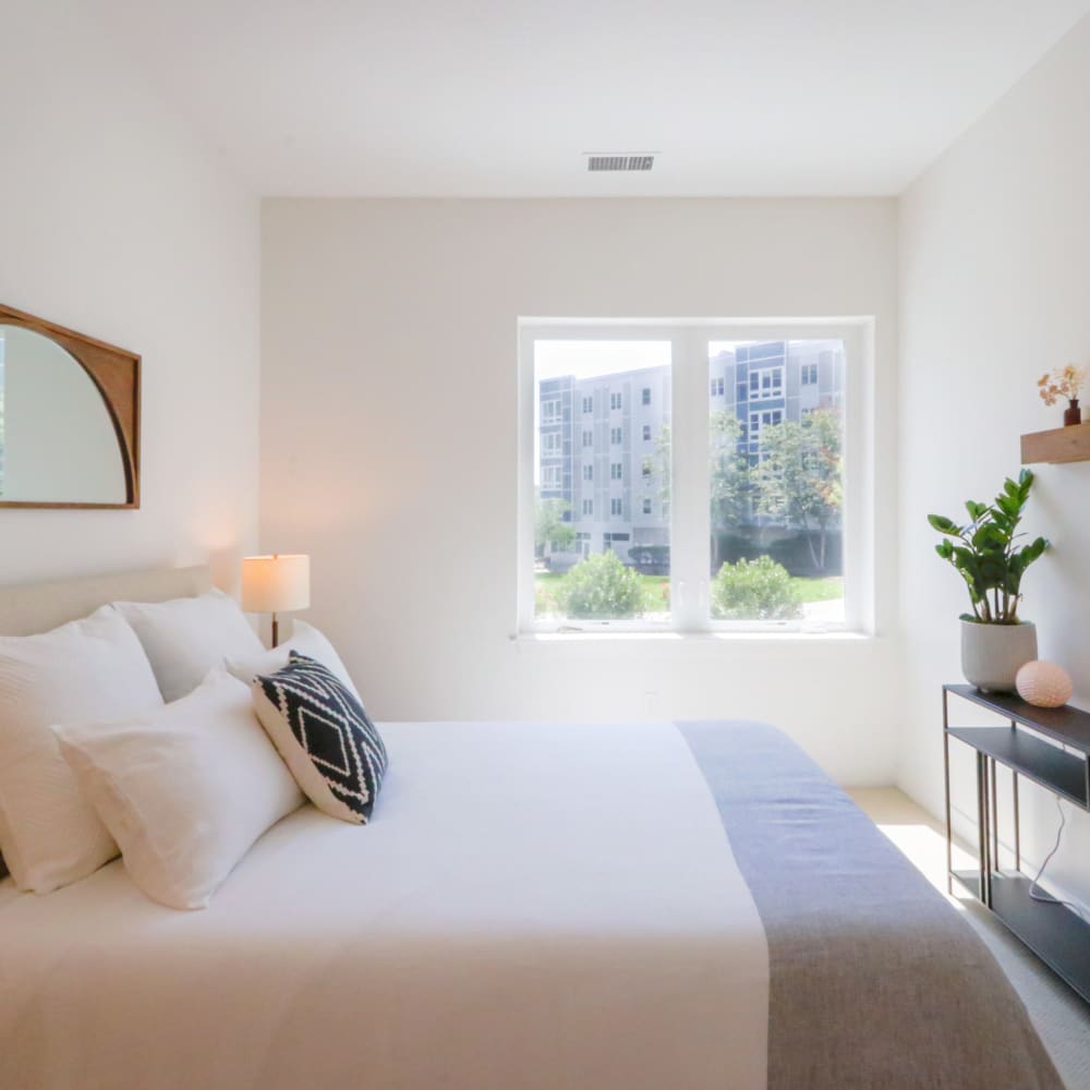 Model bedroom with large windows at Metro Green Court in Stamford, Connecticut