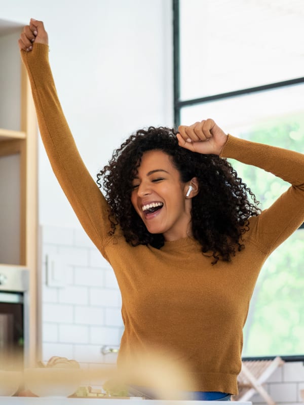 Resident dancing in the kitchen of her new home at Seagrass Apartments in Jacksonville, Florida