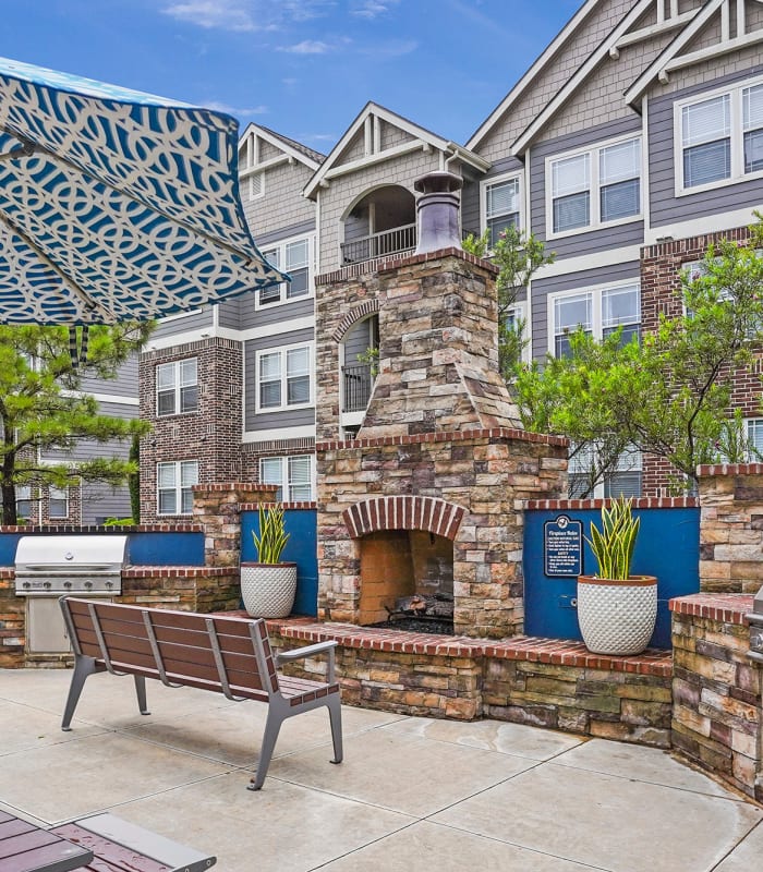 Outdoor fireplace and grills at Scissortail Crossing Apartments in Broken Arrow, Oklahoma