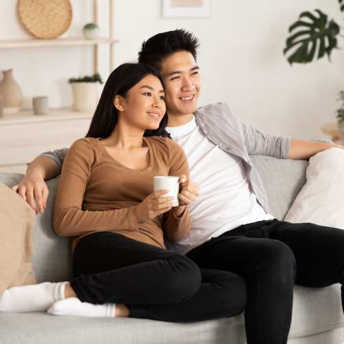 A couple sitting together on a couch together at Copper Steppe in Parker, Colorado