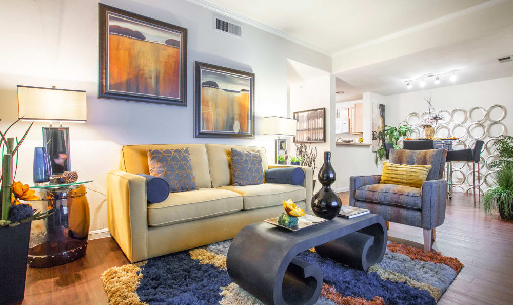 Well-decorated living area in the open-concept floor plan of a model home at Riata Austin in Austin, Texas