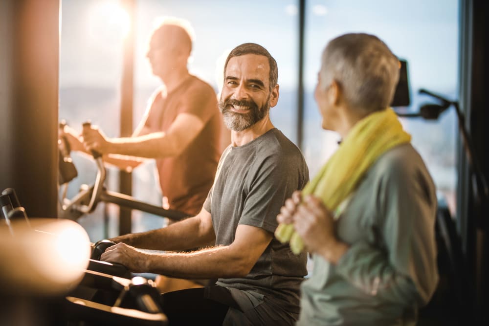 Residents exercising together in the fitness center at Mariposa at River Bend in Georgetown, Texas