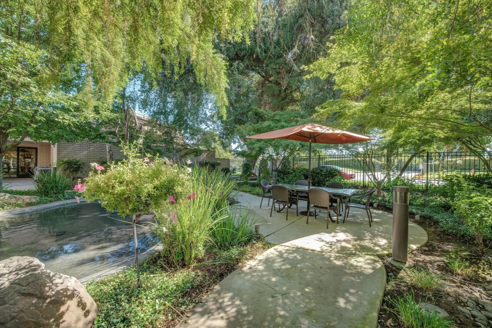 Outdoor courtyard with water feature at Campus Commons Senior Living in Sacramento, California