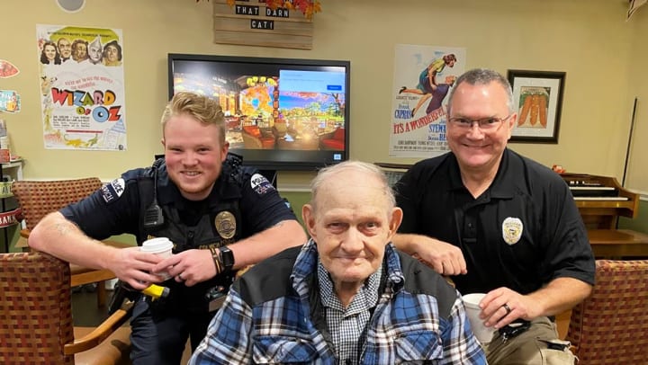 Chisholm Place Memory Care Residents celebrate Coffee with a Cop Day in Wichita