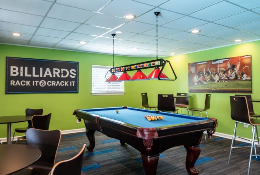 Game room with billiards and seating at Lighthouse at Twin Lakes Apartment Homes in Beltsville, MD