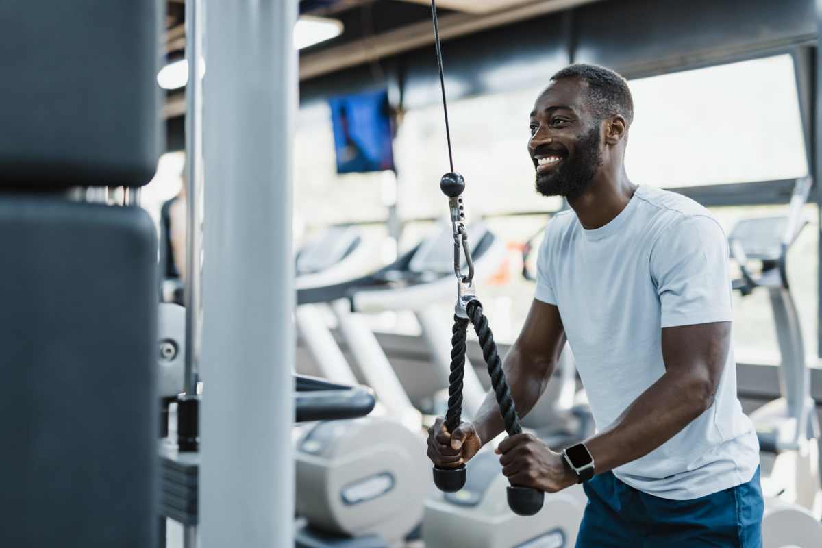 Resident doing work-out in fitness center at Whispering Pines Ranch in The Woodlands, Texas