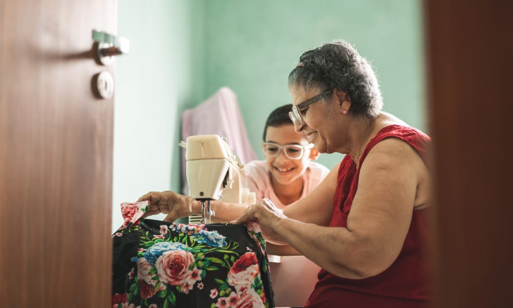 A resident and child sewing at Ativo Senior Living of Prescott Valley in Prescott Valley, Arizona.