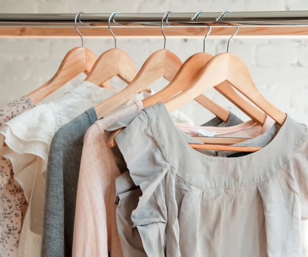 Clothes hanging in a closet at Alta Grande