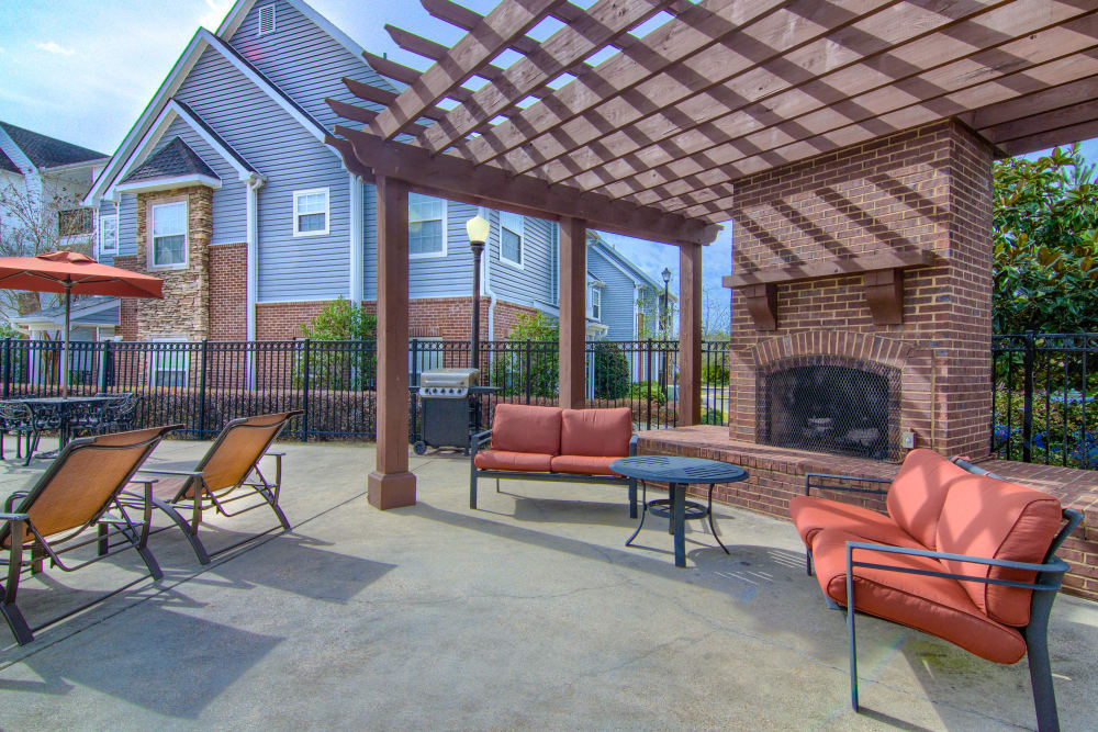 Large outdoor lounge with a fireplace and gas-fueled barbecues at Reserve at Long Point in Hattiesburg, Mississippi