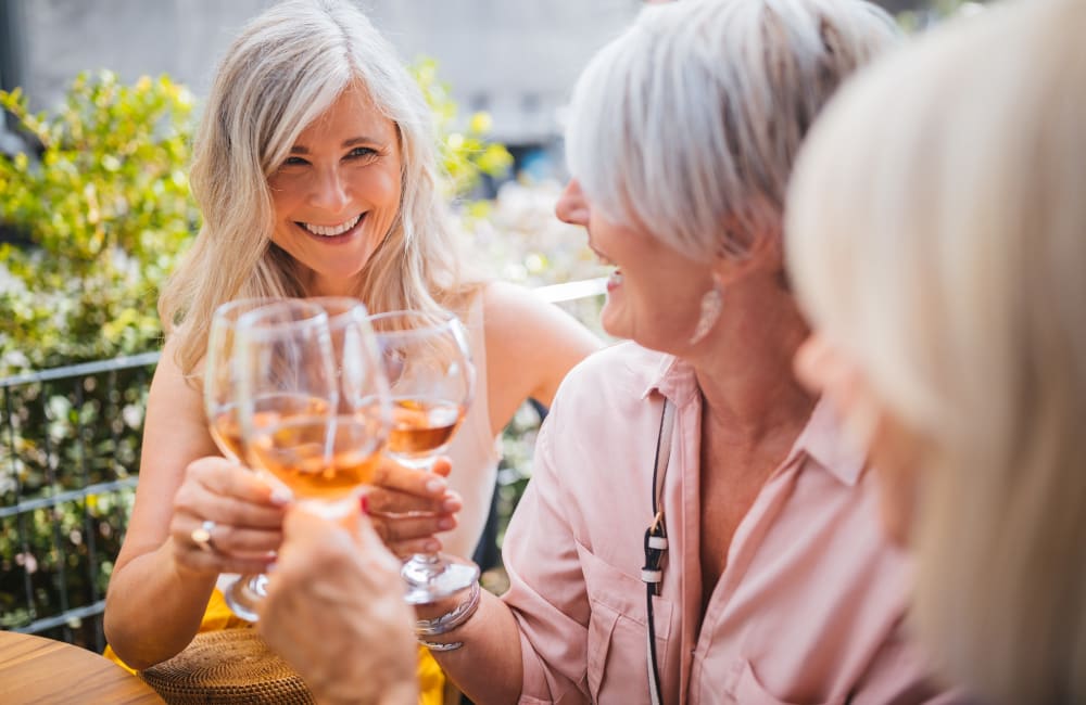 Residents drinking wine outside at Quail Park at Browns Point in Tacoma, Washington